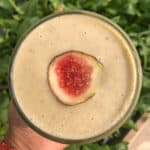 Fresh fig smoothie in glass with creamy texture, topped with half a fig, perfect for healthy breakfast recipes.